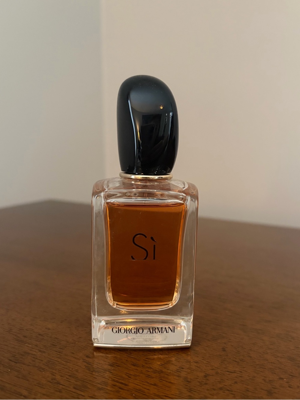 Giorgio Armani Sì Bottle with Amber Liquid and Black Cap